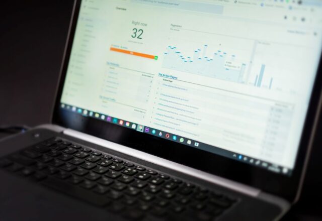 A laptop displaying an analytics dashboard with real-time data tracking and analysis tools.